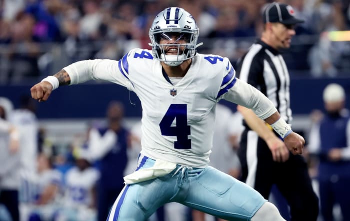 Dec 11, 2022; Arlington, Texas, USA; Dallas Cowboys quarterback Dak Prescott (4) celebrates after throwing a touchdown pass during the first half against the Houston Texans at AT&T Stadium.